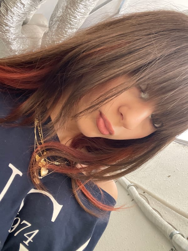 Woman photographed indoors wearing vintage-style sweatshirt in Raanana