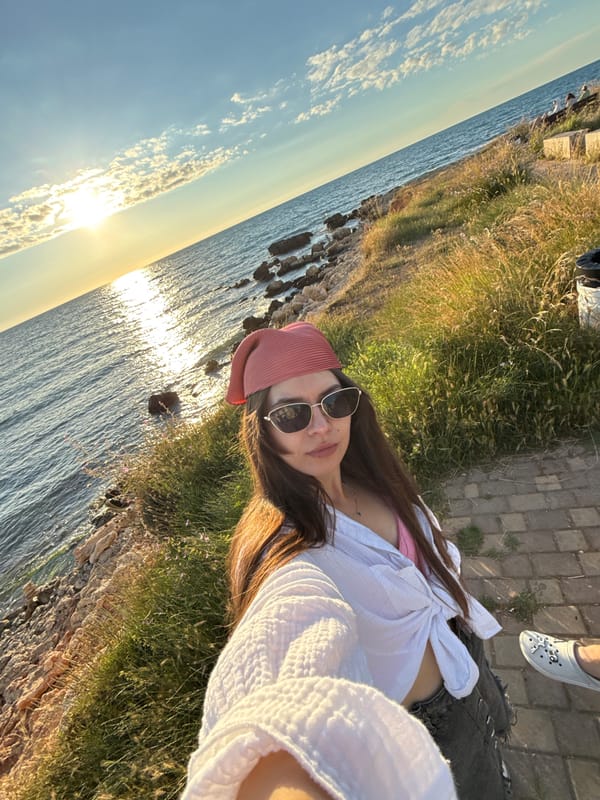 Golden hour on the rocks, drinks in hand, ocean at sunset