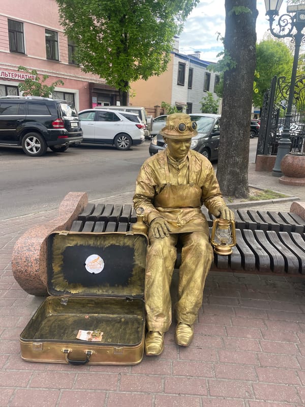 Street performer, sculptures, flowers documented in downtown Brest