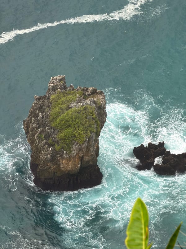 Aerial views of a wave-battered rock off Kuta Selatan