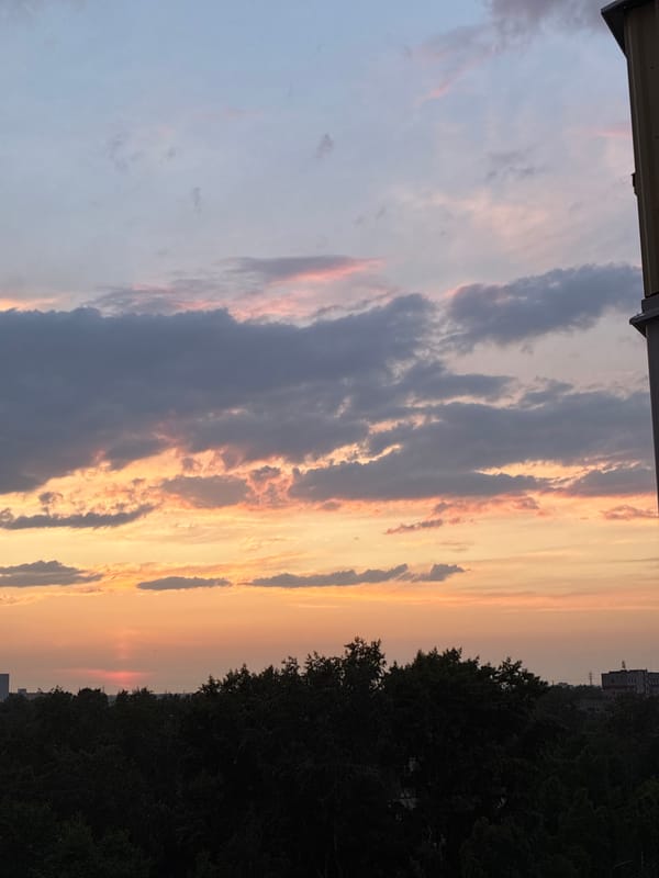 Dramatic sunset transforms city skyline through vibrant evening colors