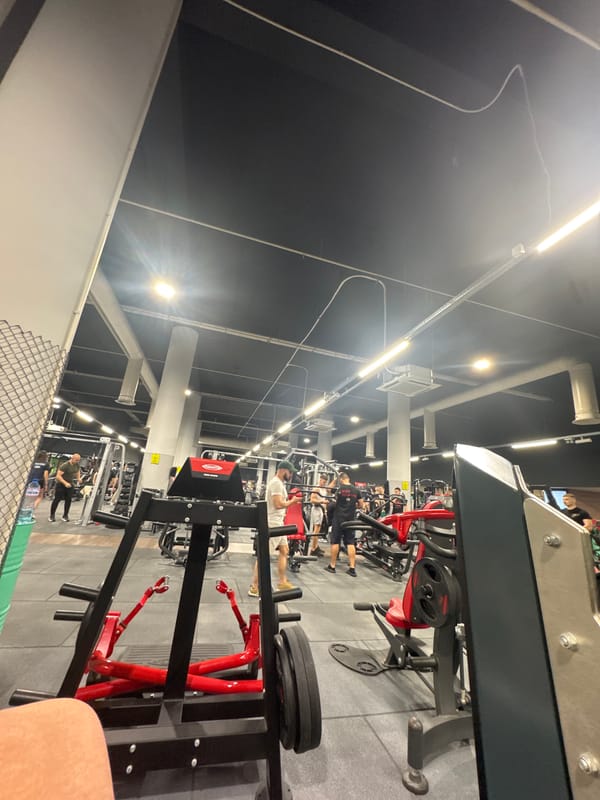 Gym patrons exercise on chest press machines in Varna