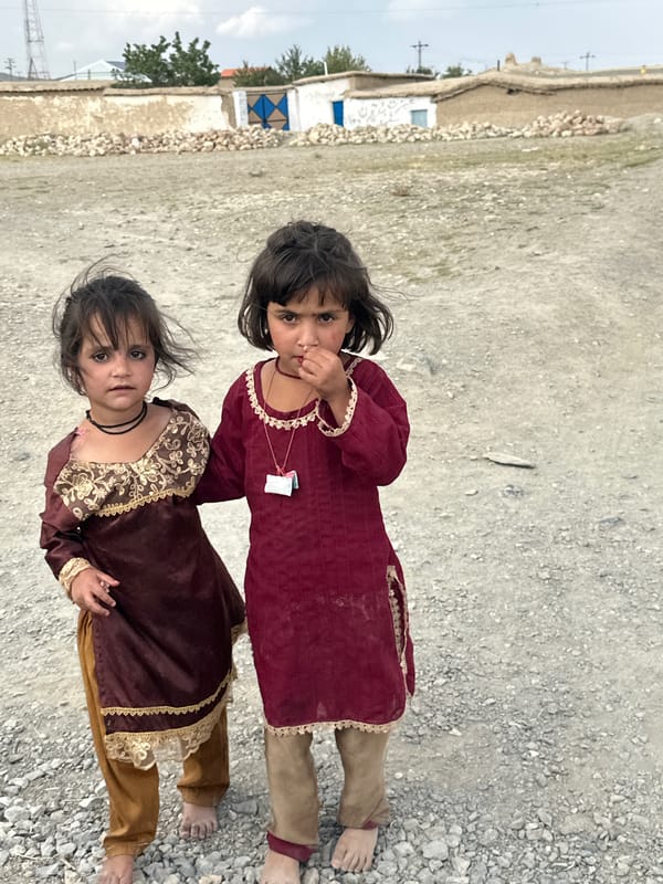 Traditional dress on a gravel road in rural Balochistan