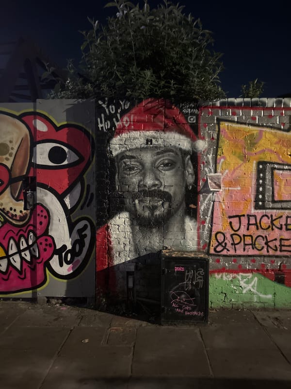 Street art documented on London brick wall at night