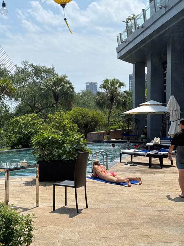 Woman relaxes poolside in early morning Đà Nẵng scene