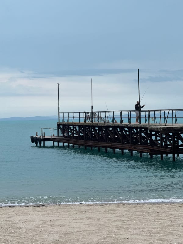Woman documents beach visit in Ravda, Bulgaria on overcast day