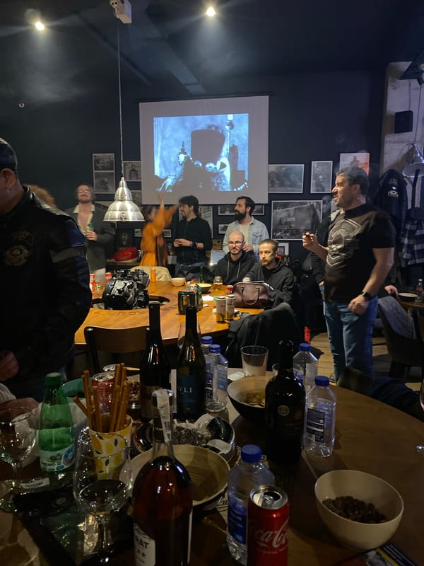 Group gathers around table in dimly lit venue