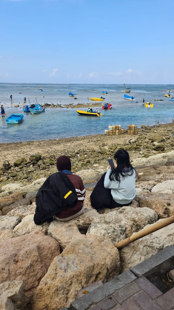 Kiteboarding, beachside relaxing, and traditional dress on Denpasar's shore