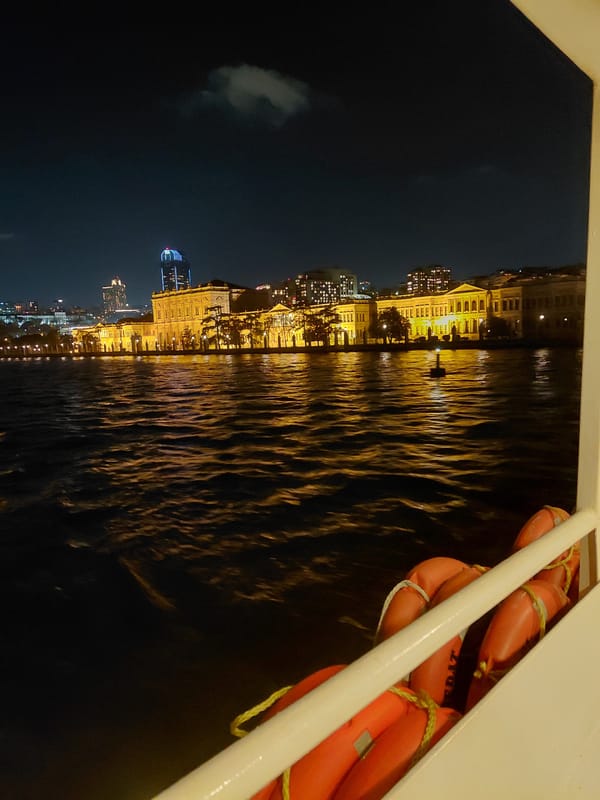 Nighttime ferry view captures illuminated Istanbul waterfront from Beşiktaş