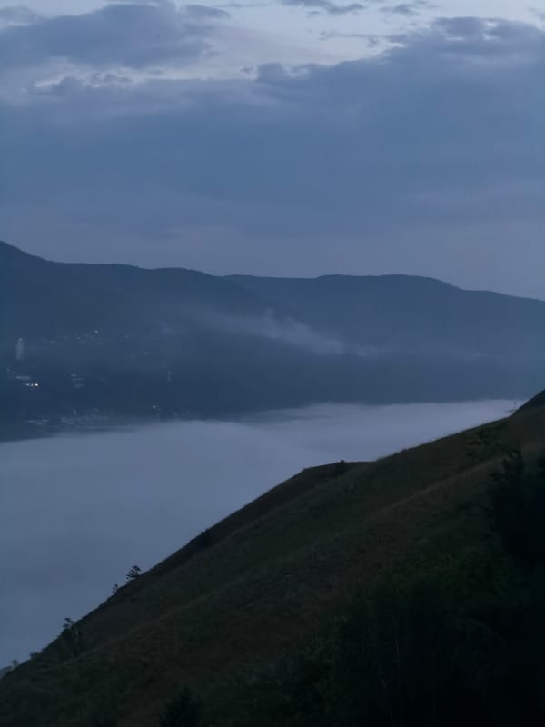 Dusk over Krasnoyarsk: river ferry, mountains, and city lights