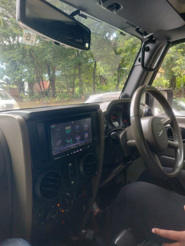 Person drinks energy beverage inside Jeep in Dar es Salaam