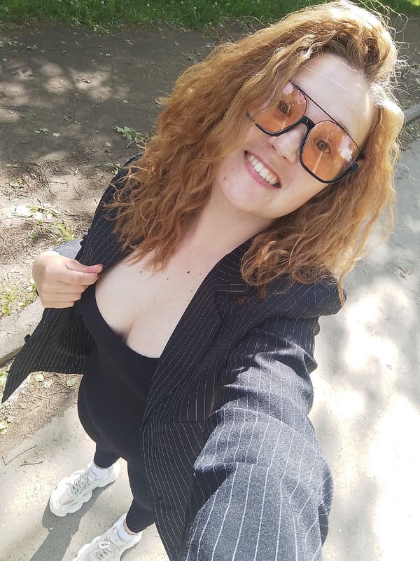 Woman in orange sunglasses enjoys outdoor time with child