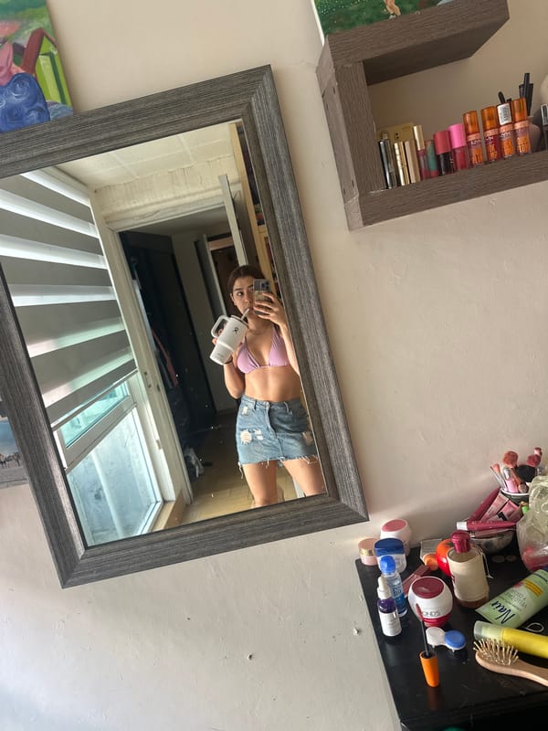 Woman takes mirror selfie in pink bikini, Puebla