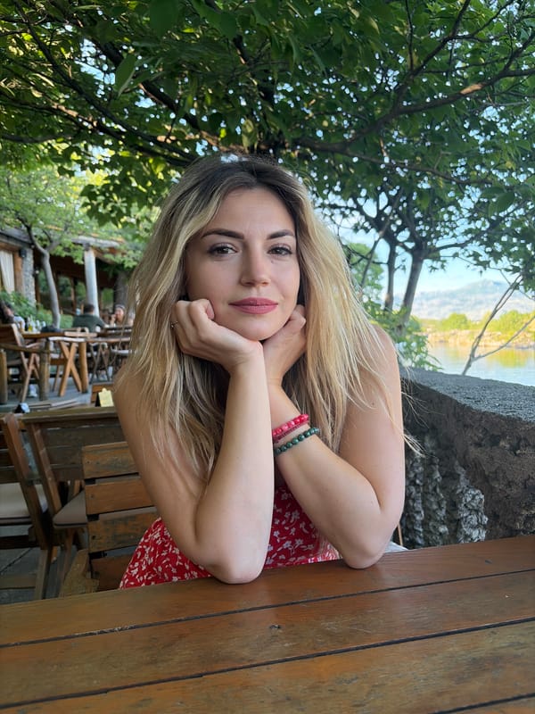 Woman dines waterside in Podgorica amid scenic lake views