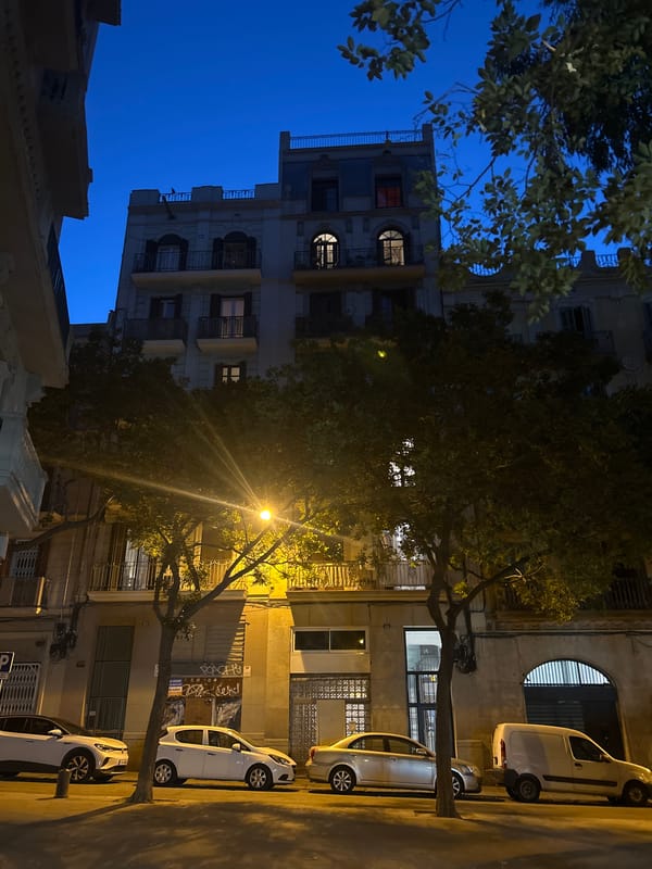 Acteco delivery truck on a Barcelona street at dusk