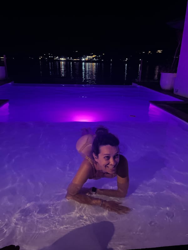 Nusa Penida infinity pool night with colorful lighting
