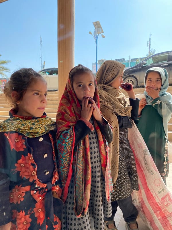 Young girls gather on Kandahar streets, steps