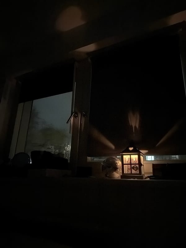 Berlin resident observes foggy night through open window