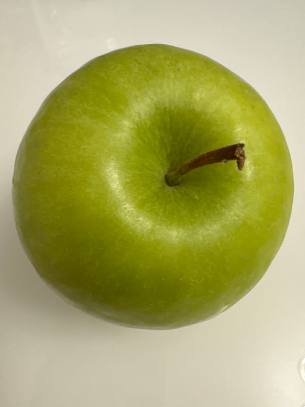 Green apples and artificial flowers arranged in Berlin still lifes.