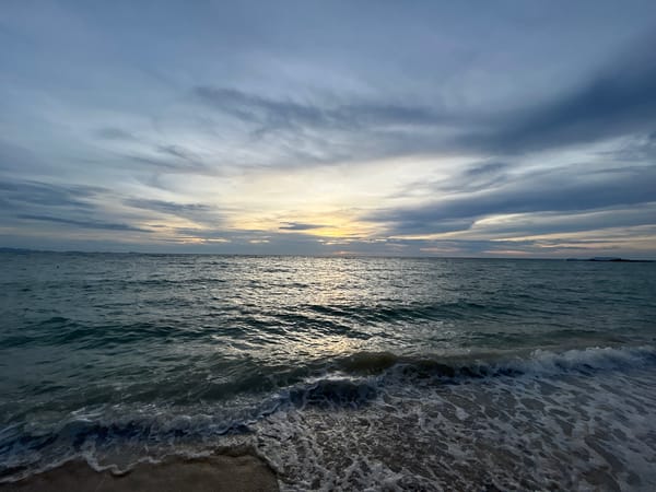 Koh Phangan beach at dusk, calm water and sunset clouds