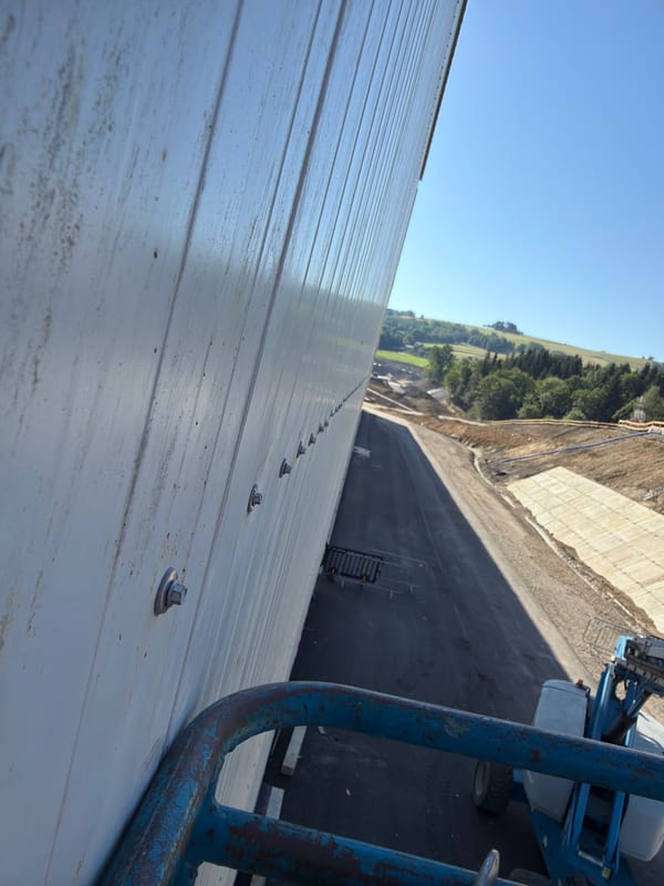 Boom lift and metal building work at a Stróża construction site