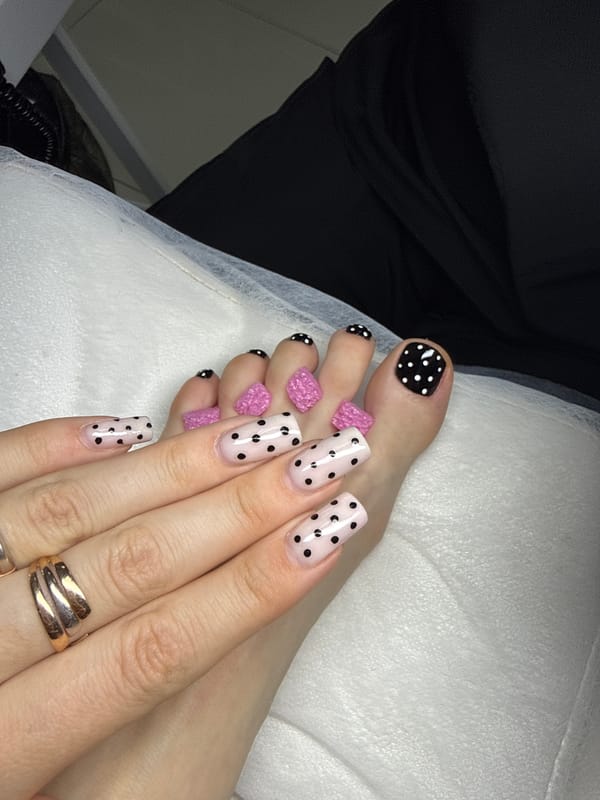 Pink polka dot manicure displayed in Batumi, Georgia