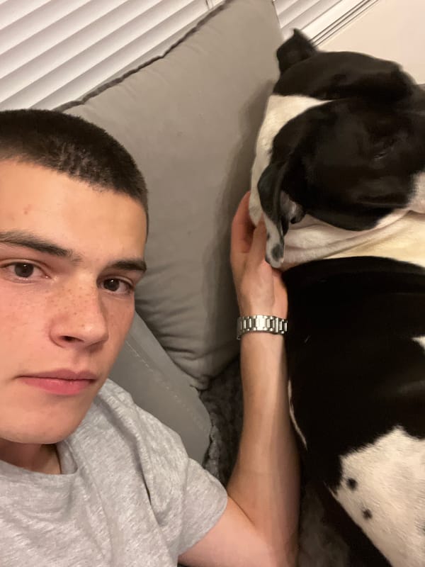 Man relaxes with dog at home in Plovdiv