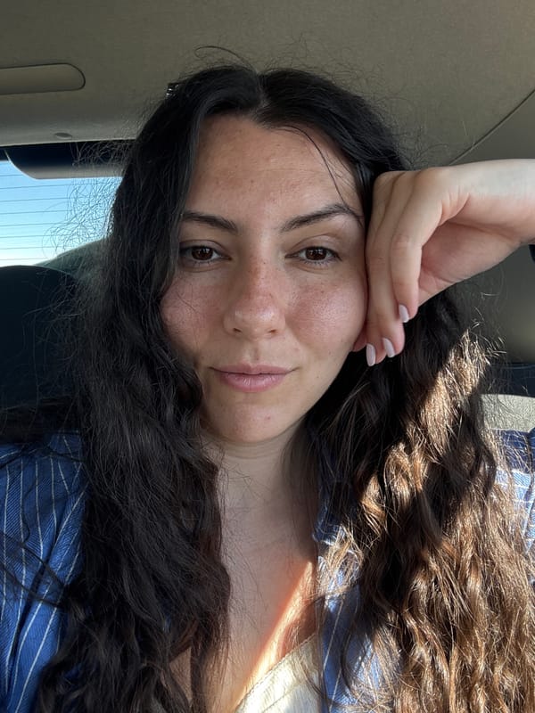 Woman takes selfies while reclining in moving vehicle