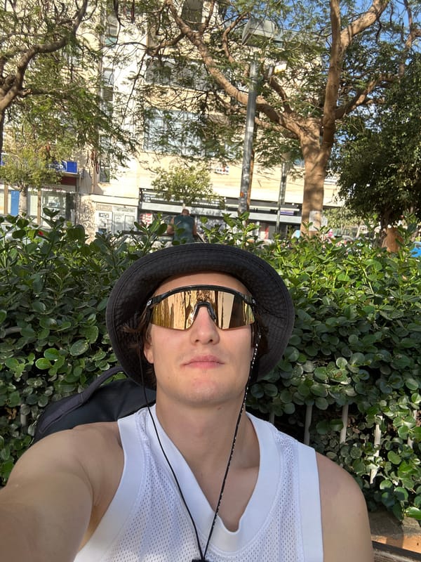 Person photographed amid urban greenery in Tel Aviv