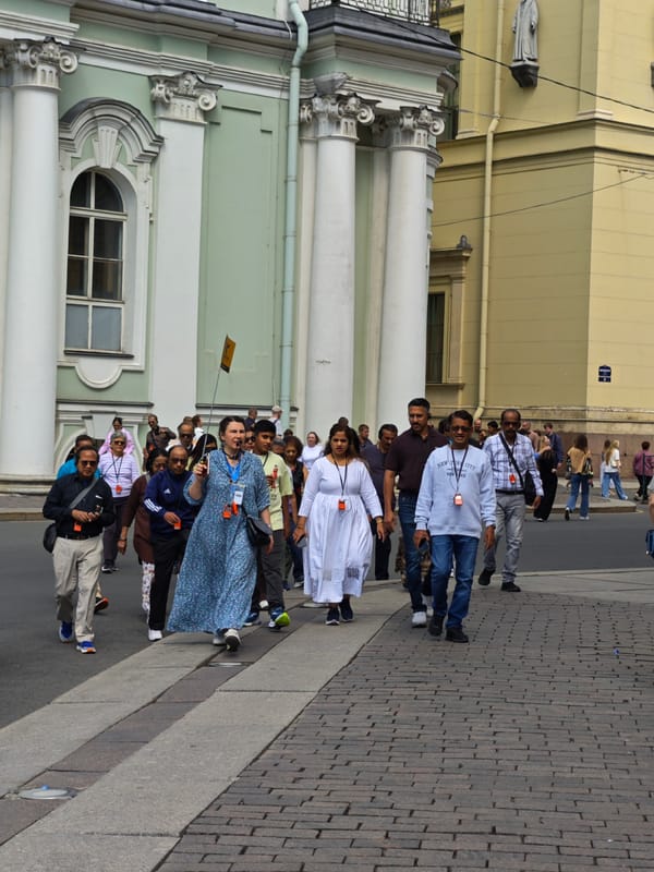 Tourist group and child explore area near historic building