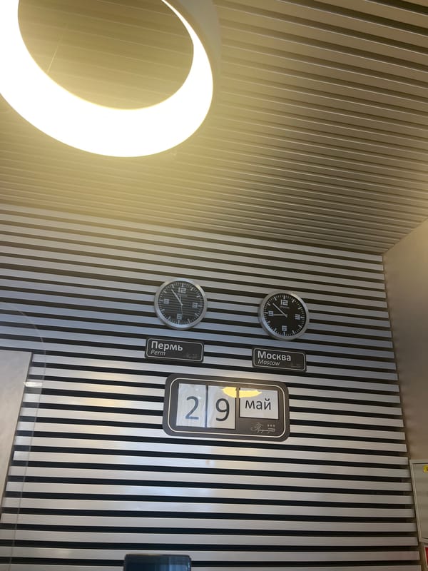 Russian timekeeping display and green ID badge documented