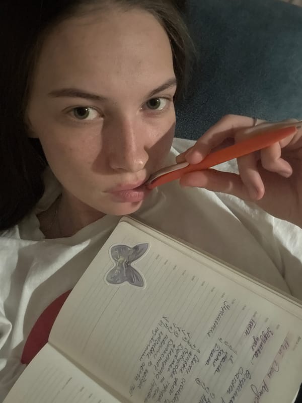 Woman journals in bed during evening in Perm, Russia
