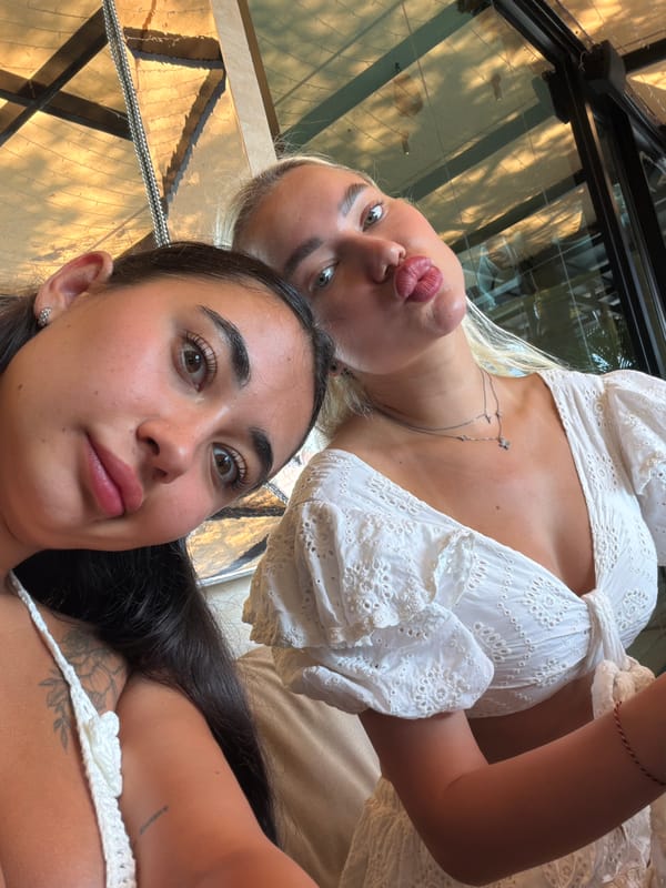 Two women document breakfast at Thai beachside restaurant