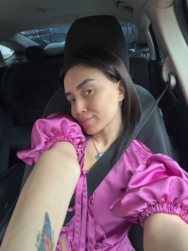 Woman in satin top observed as car passenger in Tbilisi