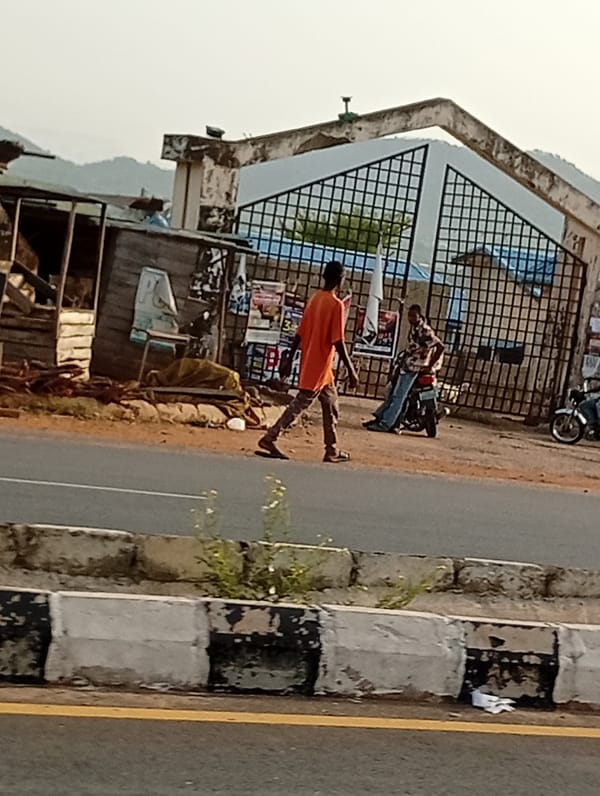 Morning street life documented in unidentified urban settlement