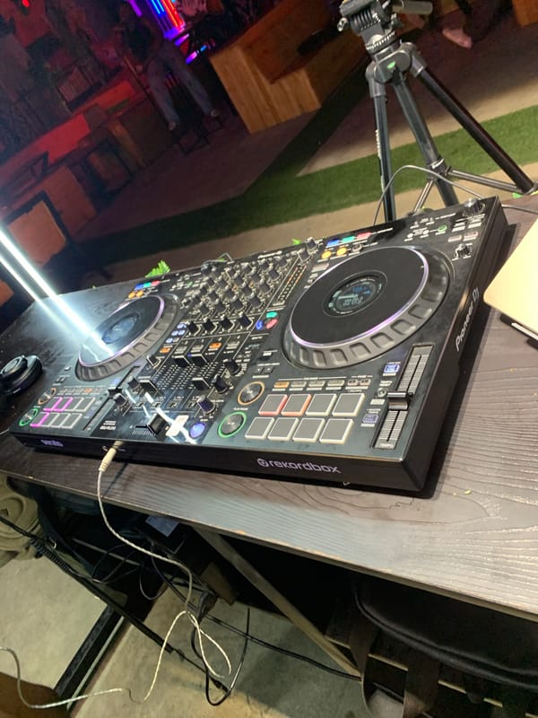 Outdoor nighttime DJ event draws dancers and drinkers