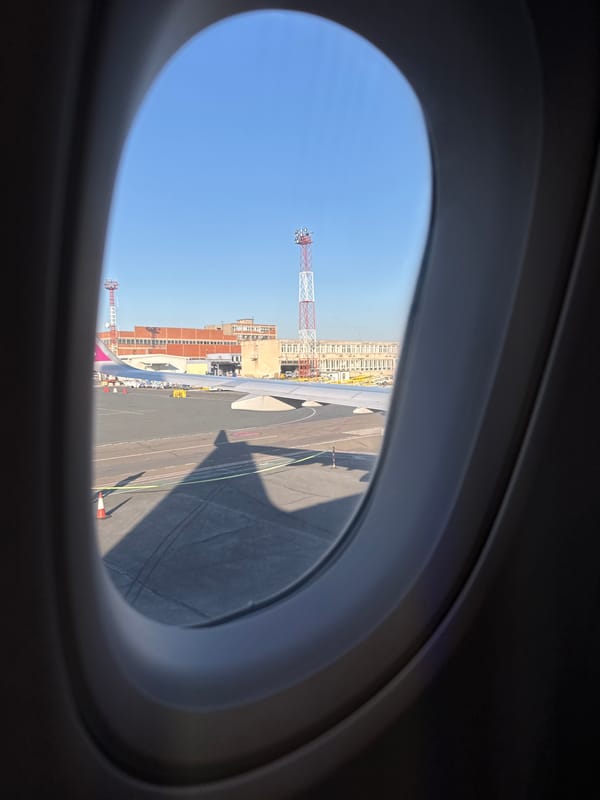 Passenger documents airplane window view at Belgrade airport