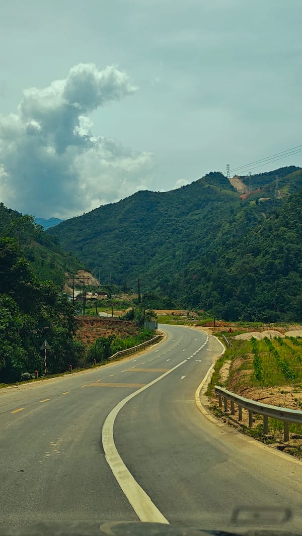 Vehicle travels winding mountain road in Duong Quy, Vietnam