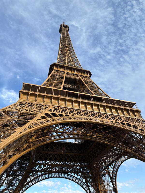 Eiffel Tower iron lattice reaching into a clear Paris sky