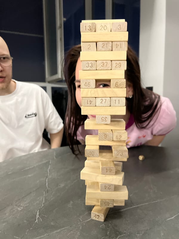 Friends play Jenga at apartment party in Vologda, Russia