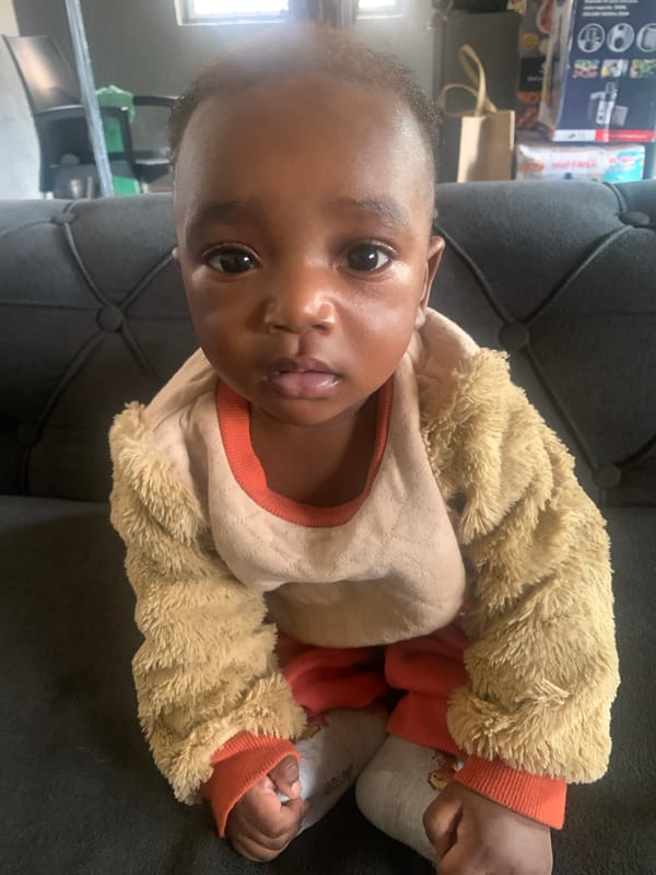 Baby resting on sofa in Barakin Akawo, Nigeria