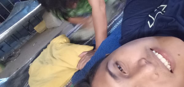 Person takes selfie on blanket in Sumput, Indonesia