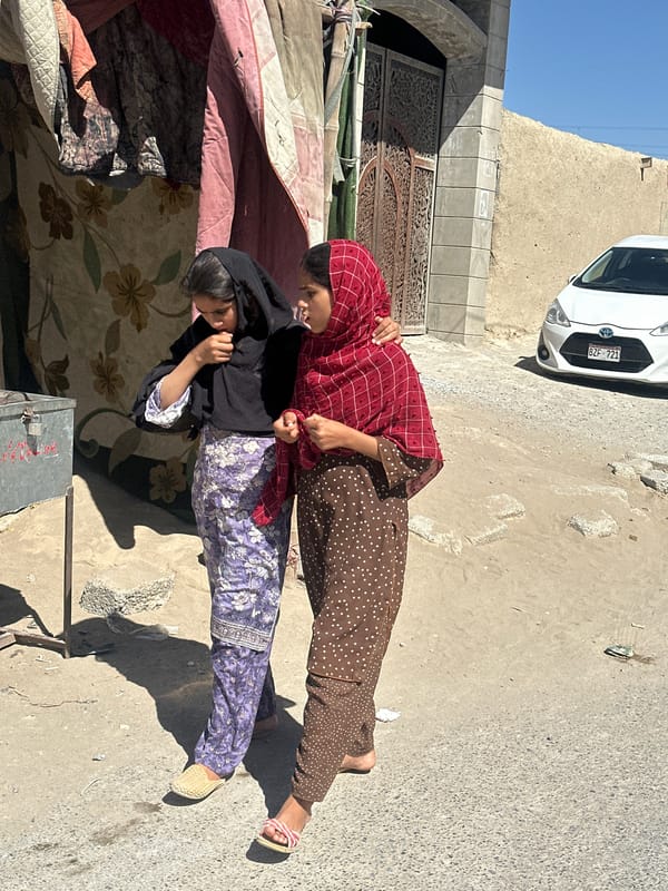 Two women walk together in Quetta semi-urban area