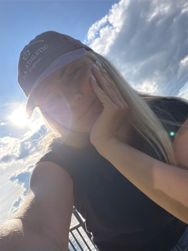 Woman takes selfies at Votkinsk reservoir during sunny afternoon