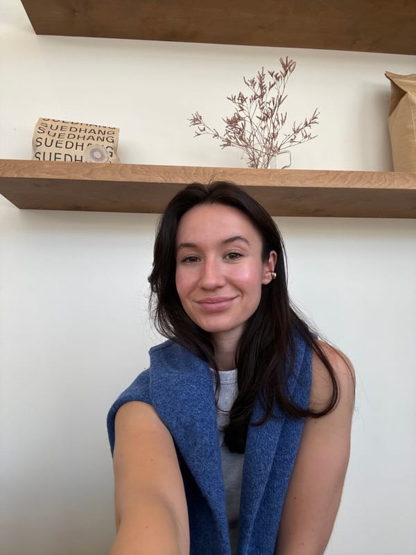 Woman smiles for camera in Tel Aviv indoor setting