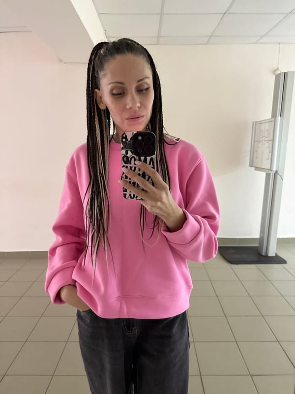 Woman in pink sweatshirt photographed at multiple Rusanovo locations
