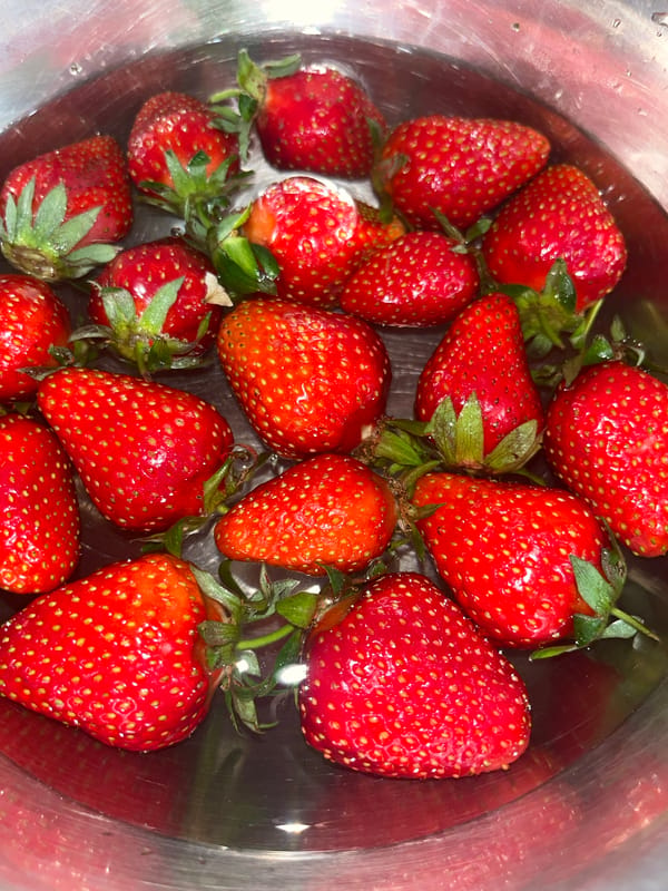 Fresh strawberries documented soaking in bowl in Sevastopol