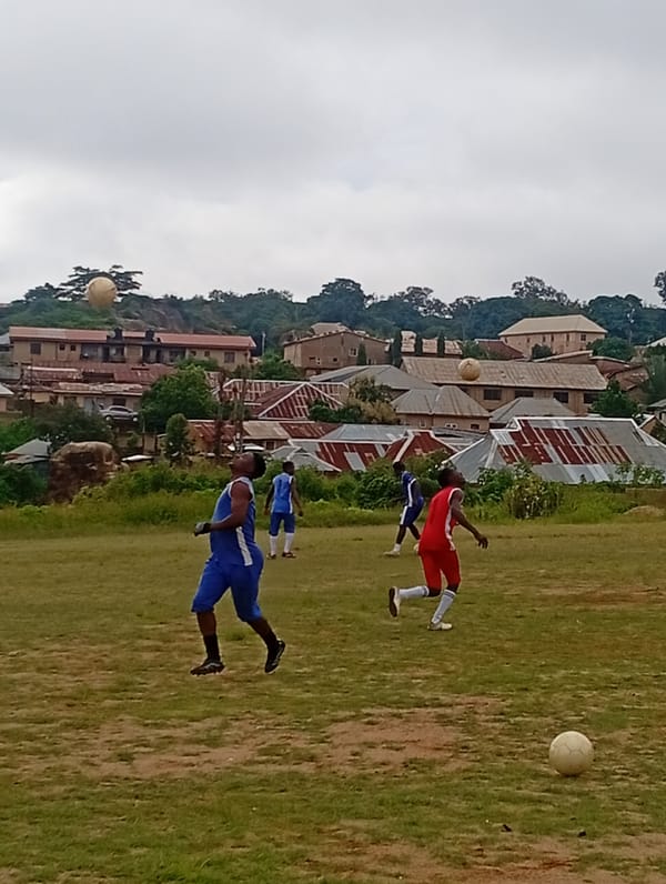 Soccer training session on a Jos field, red vs. blue kits