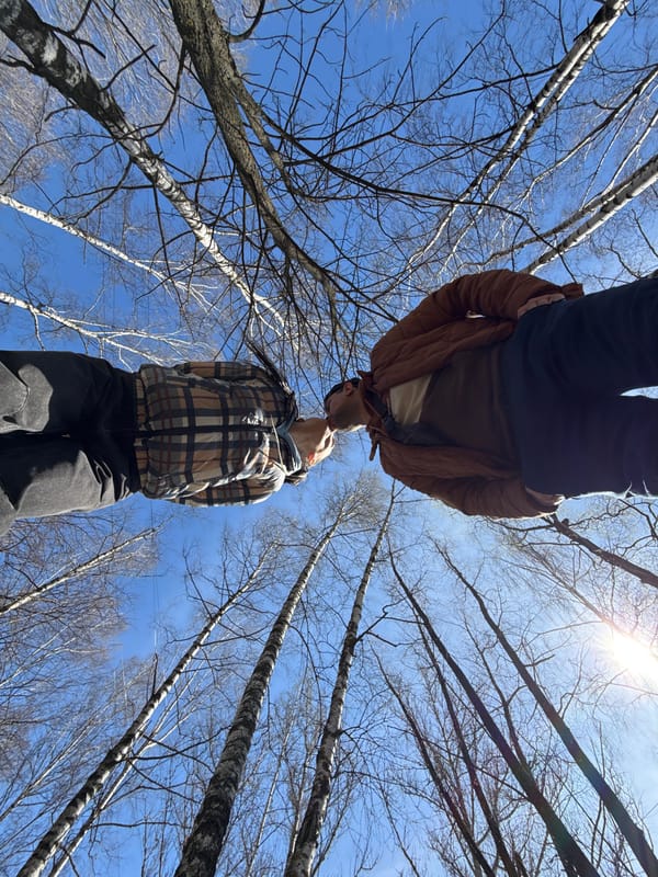 Couple shares playful moment in Rusanovo forest