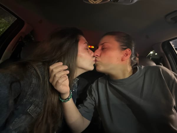 Young women share intimate moments in car near Sofia square